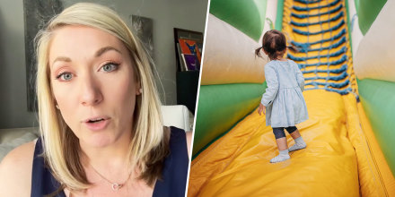 Attorney Shannon Schott and a child staring up at a bouncy house.